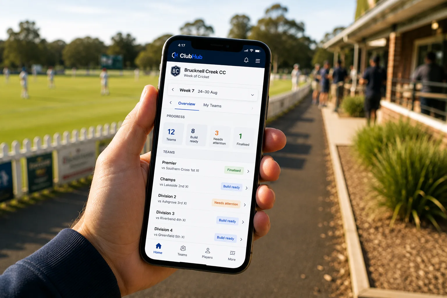Club volunteer viewing ClubHub on a phone beside a cricket ground.